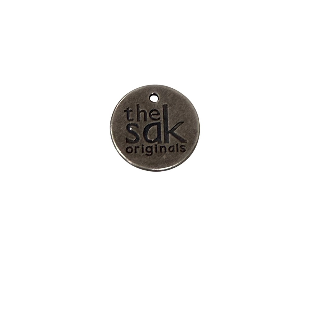 The Sak Originals Gunmetal Round Logo Bag Charm Replacement Tag 1 Inch